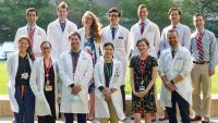 Thirteen Pulmonary and Critical Care Medicine fellows stand outdoors for a group photo